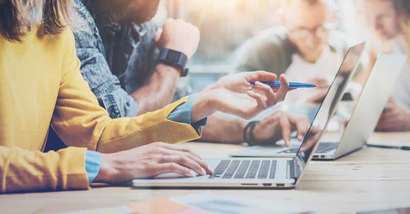 Mehrere Personen arbeiten am Laptop
